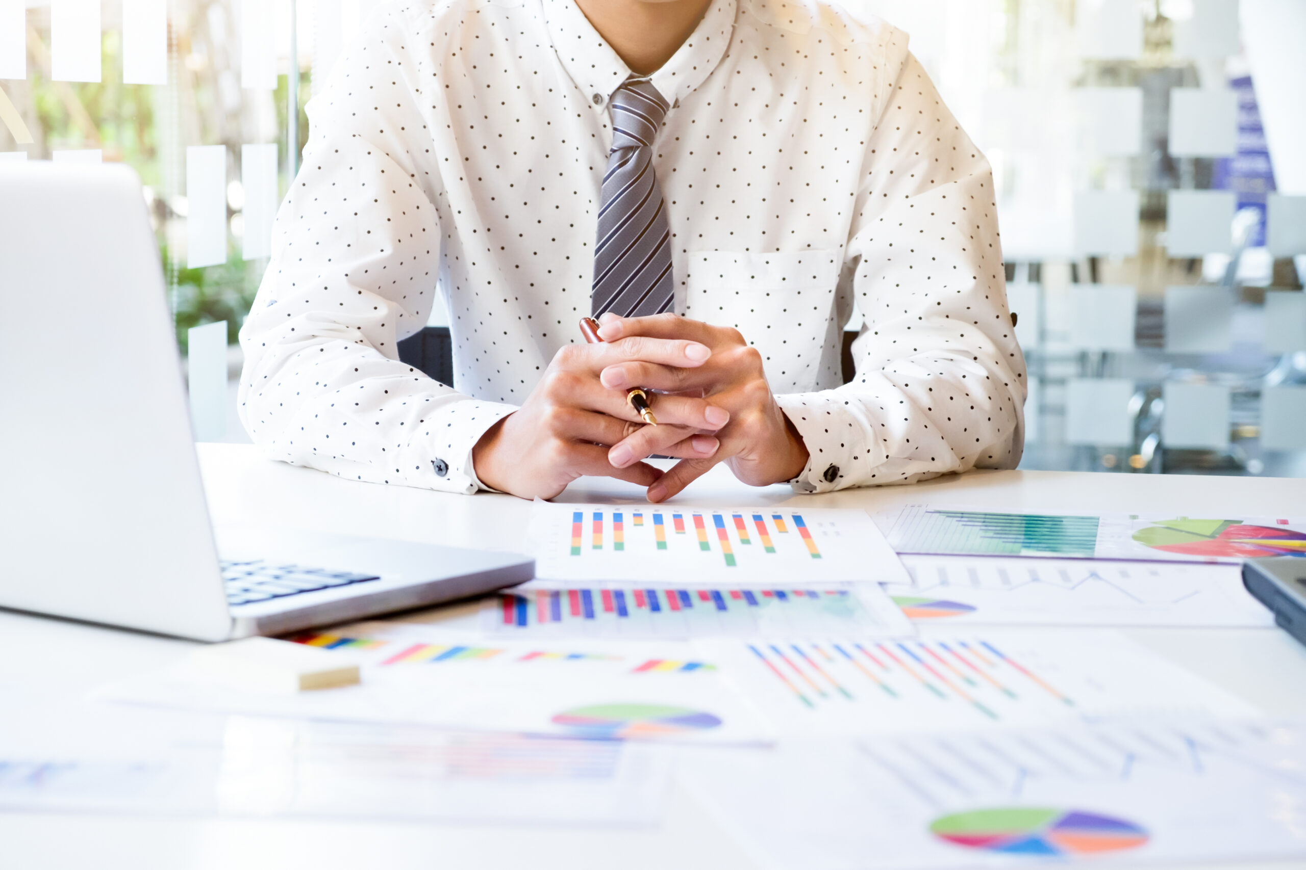 Startup businessman working with business documents on office table with graph